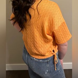 Orange buckle cropped top